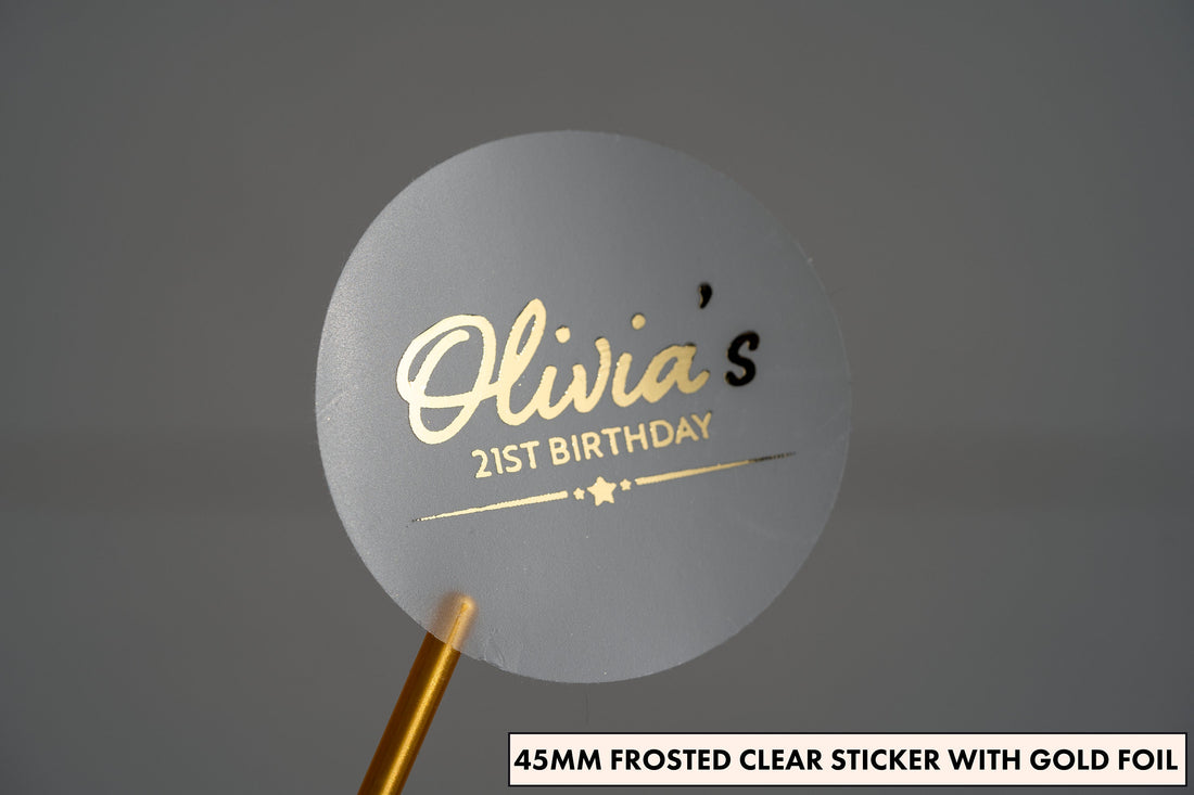 A personalised metallic foil birthday sticker with the name of the birthday person written in a lovely handwritten font. Underneath the name is the age and a line with stars in the middle of it. The entire design is adorned with metallic foil.