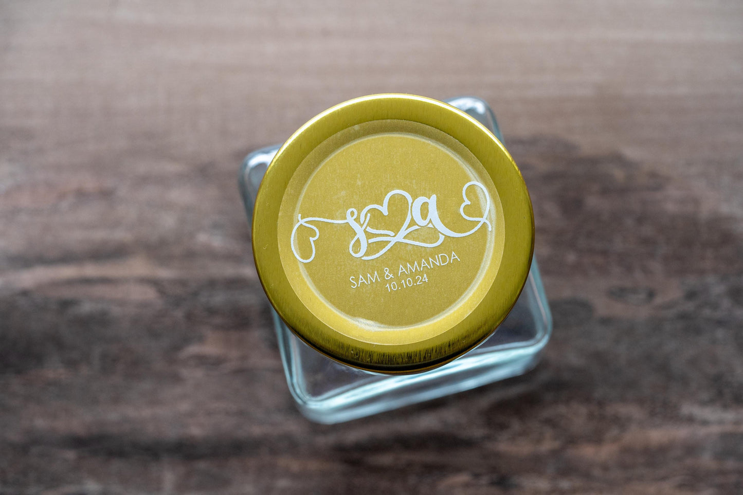 This is a perfect example of how these stickers can be used as part of wedding favours. The sticker is on top of a jar with a gold lid which makes the white font really stand out and prominent.