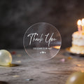 A transparent sticker with silver foil text saying 