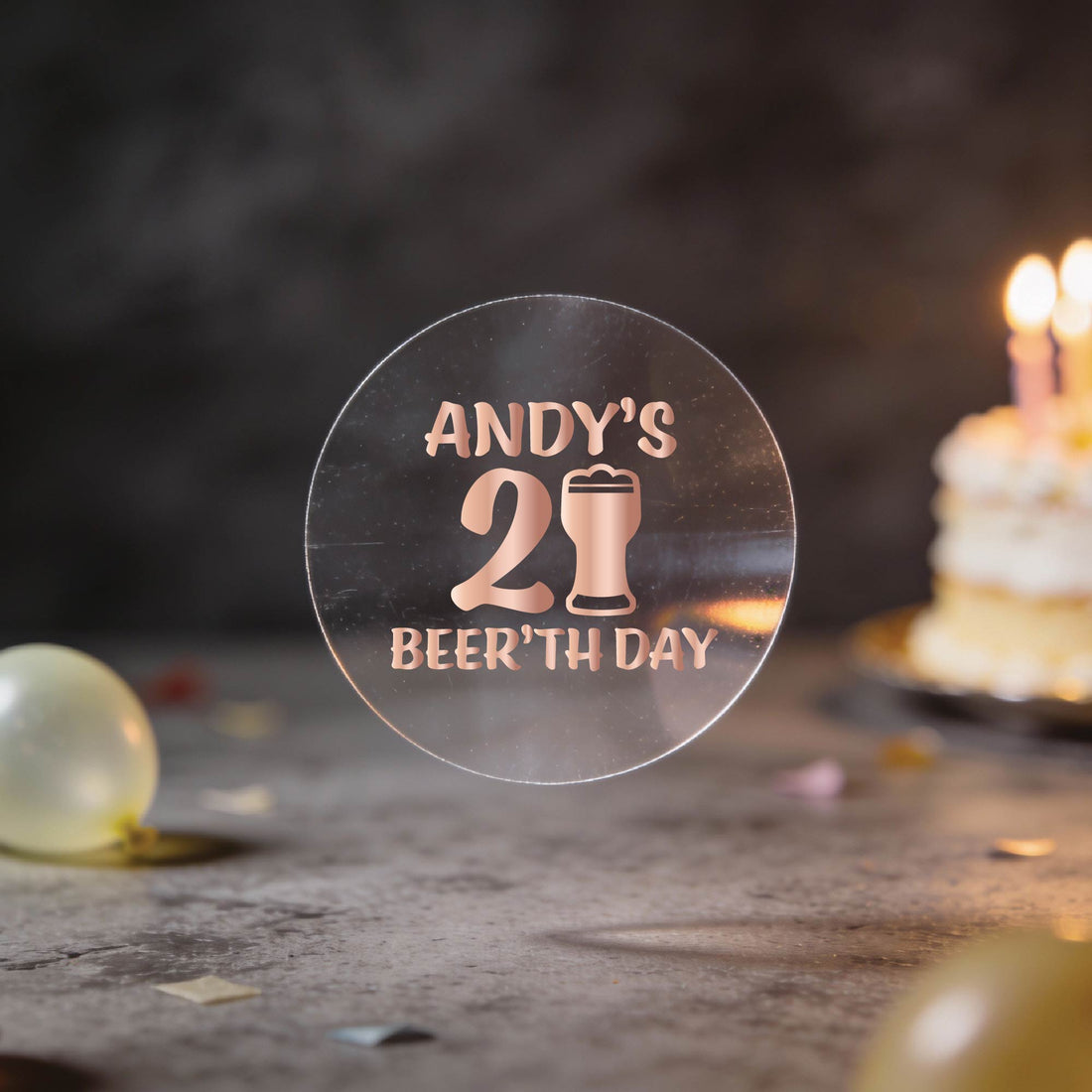 A clear round sticker with gold foil text reading 'ANDY'S 21st BEER'TH DAY' and a beer glass icon.