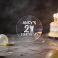 A clear round sticker with silver foil text reading 'ANDY'S 21st BEER'TH DAY' and a beer glass icon.