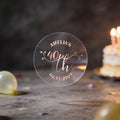 A clear round sticker with rose gold foil text reading 'AMELIA'S 40th Birthday