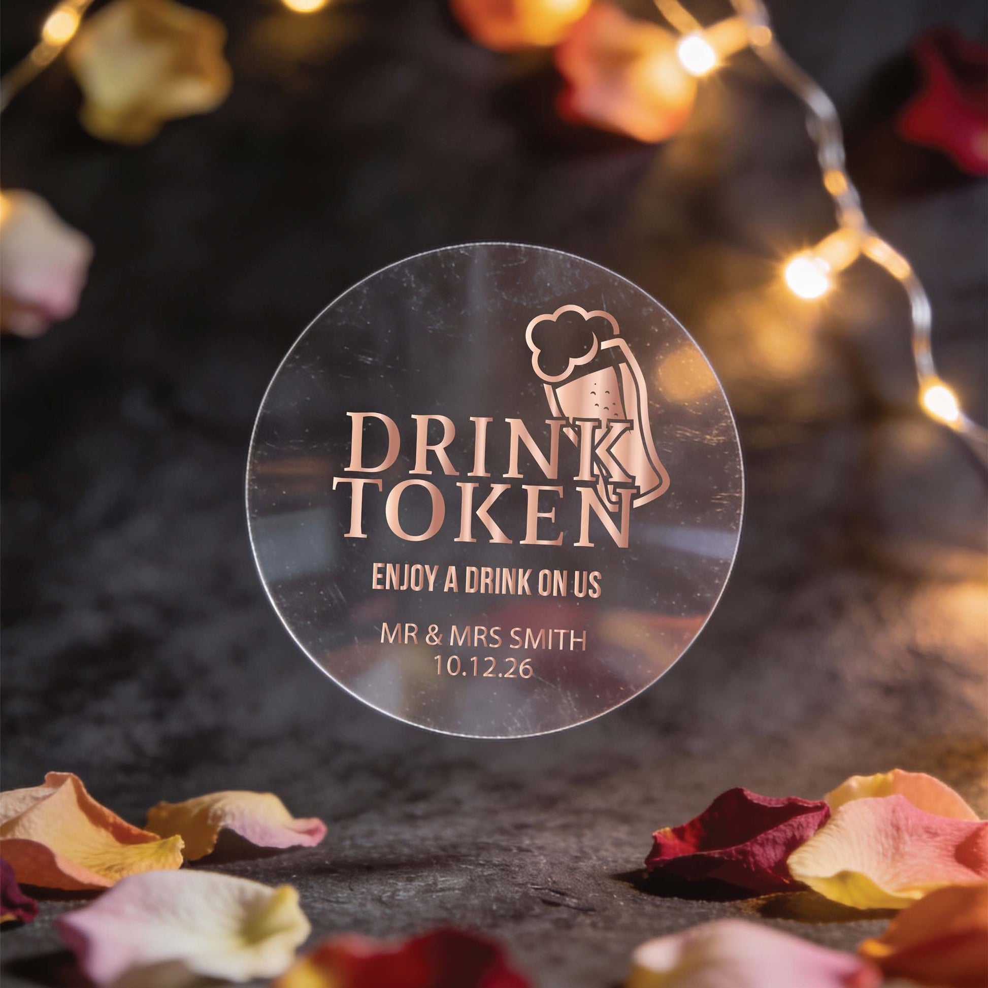 A transparent rose gold foil round sticker with "drink token: with "Enjoy a drink on us" text and a beer mug icon.