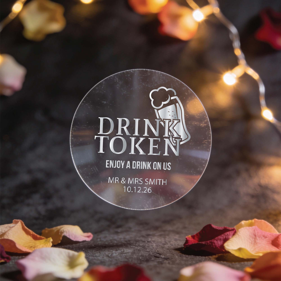 A transparent gold foil round sticker with "drink token: with "Enjoy a drink on us" text and a beer mug icon.