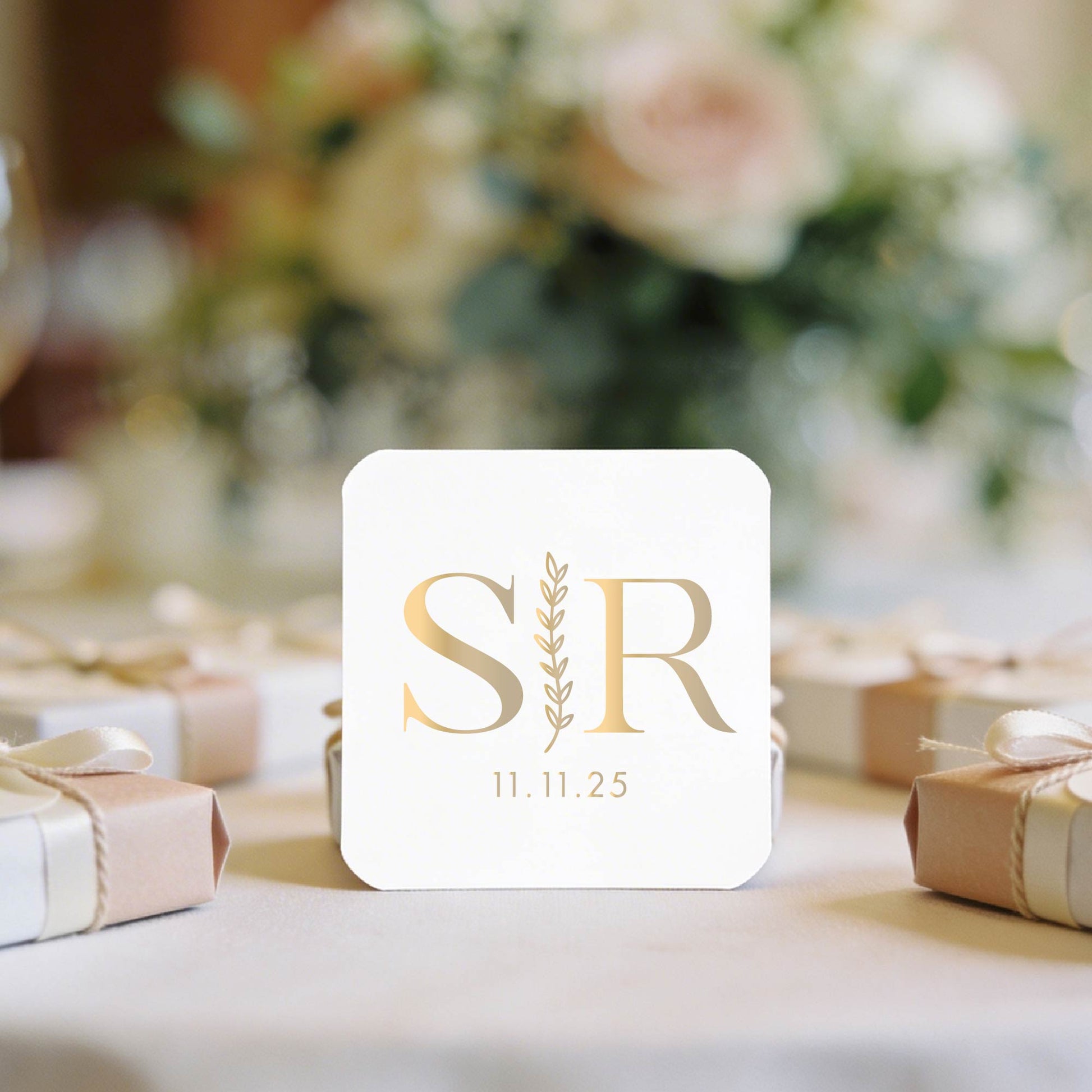 A white square stickers with gold foil initials "S | K" and date "27.09.2027"