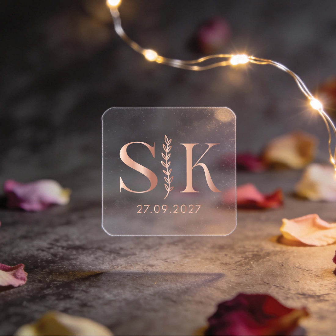 A square transparent stickers with gold foil initials "S | K" and date "27.09.2027"