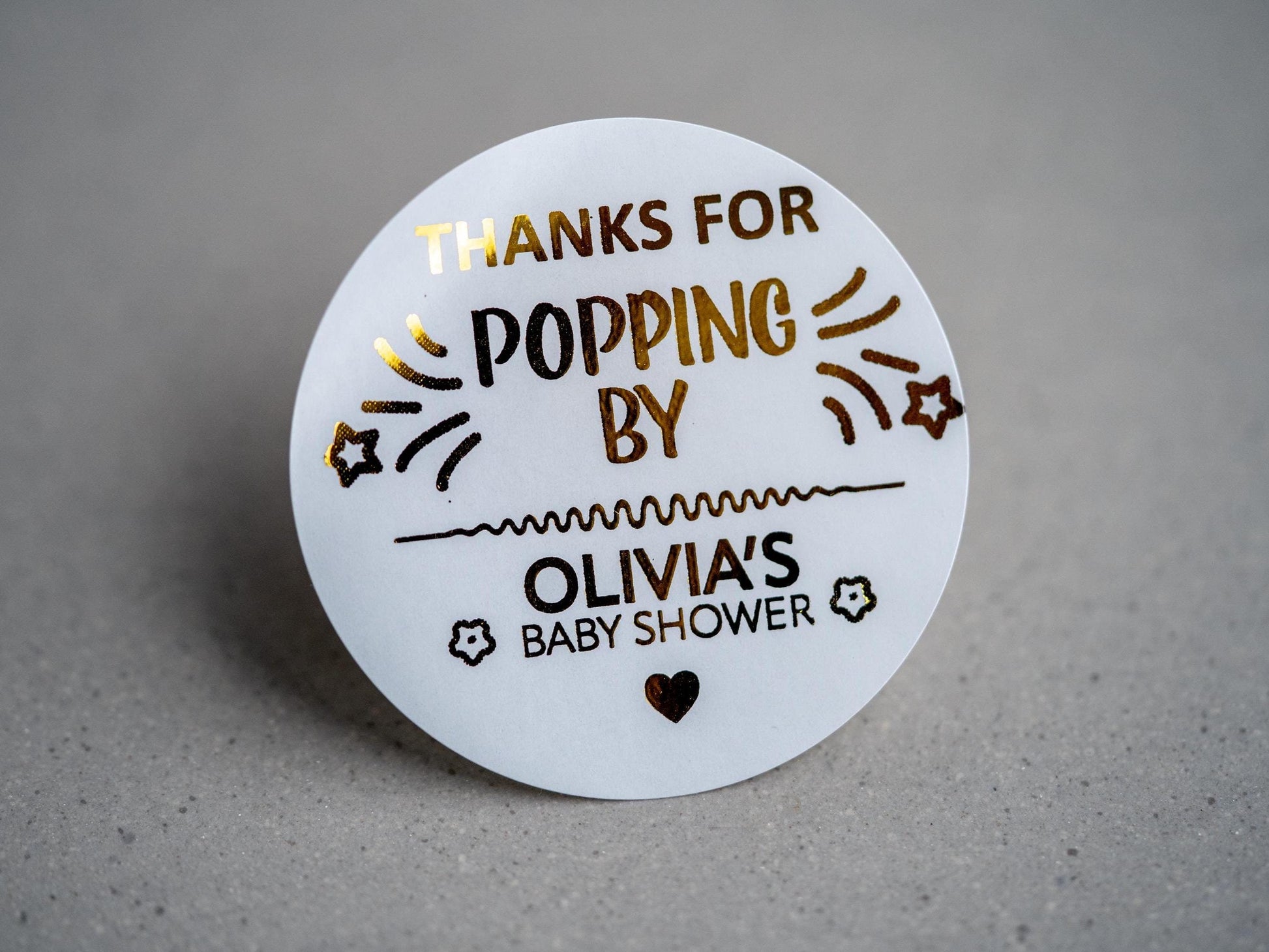 Create memorable baby shower favours with our custom &quot;Thank You for Popping By&quot; stickers, featuring gold-embossed text and shooting stars. Personalised with the mum-to-be’s name, surrounded by flowers and a heart.