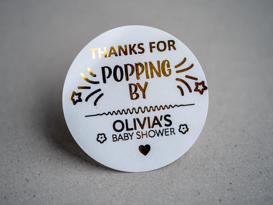 Create memorable baby shower favours with our custom &quot;Thank You for Popping By&quot; stickers, featuring gold-embossed text and shooting stars. Personalised with the mum-to-be’s name, surrounded by flowers and a heart.