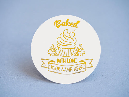 Add a touch of sweetness with our bakery sticker! Featuring a charming cupcake, &#39;Baked with Love&#39; wrapped around it and a customizable banner for your bakery name—all embossed in elegant gold. Perfect for boosting your business&#39;s visibility!