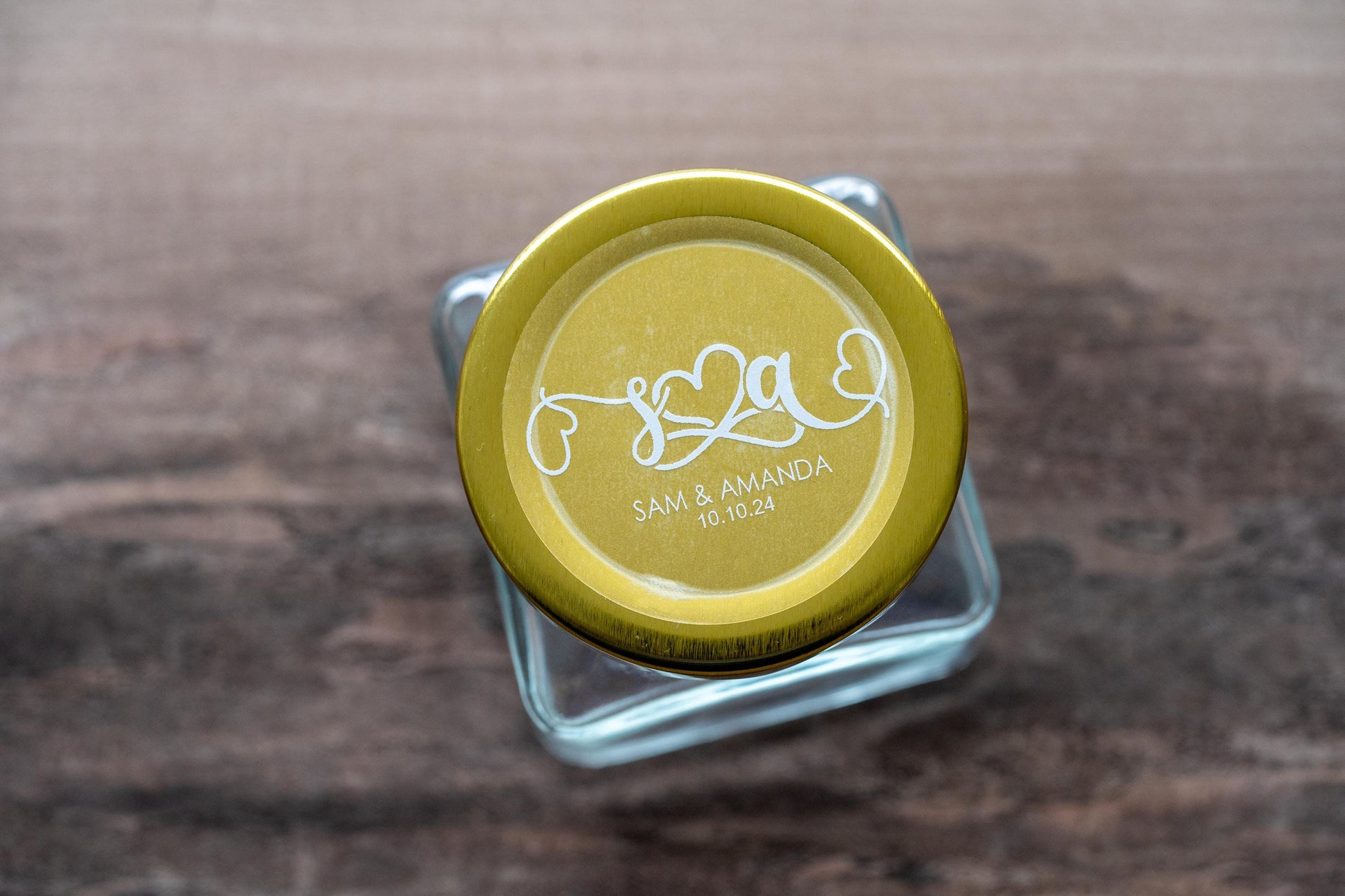 This is a perfect example of how these stickers can be used as part of wedding favours. The sticker is on top of a jar with a gold lid which makes the white font really stand out and prominent.