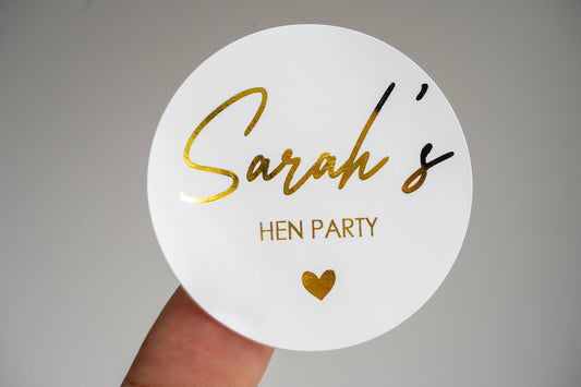 This hen party sticker features the bride-to-be&#39;s name in an elegant handwriting font, embossed with luxurious metallic foil. Perfect for adding a personalised touch to hen party favours, invitations or decorations. Ideal for custom hen party themes.