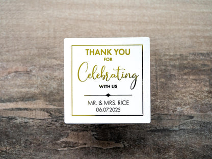 Custom square sticker with &quot;Thank You For Celebrating with Us&quot; written on the middle of the sticker. At the bottom of the sticker is the name of the bride & groom and the date of their special day. The sticker is layered with lovely metallic foil
