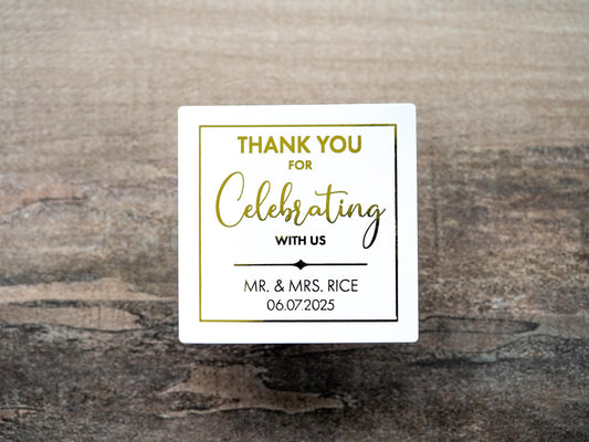 Custom square sticker with &quot;Thank You For Celebrating with Us&quot; written on the middle of the sticker. At the bottom of the sticker is the name of the bride & groom and the date of their special day. The sticker is layered with lovely metallic foil