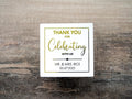 Custom square sticker with "Thank You For Celebrating with Us" written on the middle of the sticker. At the bottom of the sticker is the name of the bride & groom and the date of their special day. The sticker is layered with lovely metallic foil