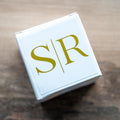 White box with 'S/R' monogram design printed in gold foil on a white gloss sticker.