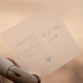 Personalised frosted square sticker with 'Thank you for celebrating with us' text, held by a hand.