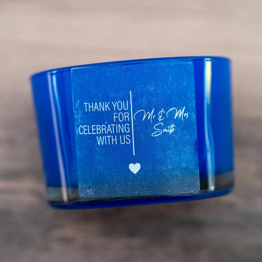 Frosted clear with lovely print with the message "Thank you for celebrating with us" and the name of the happy couple in a lovely curvy font. A line separates the words in the middle and a heart finishes the sticker off. Printed using white ink.