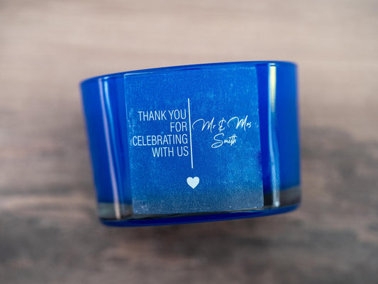 Frosted clear with lovely print with the message &quot;Thank you for celebrating with us&quot; and the name of the happy couple in a lovely curvy font. A line separates the words in the middle and a heart finishes the sticker off. Printed using white ink.