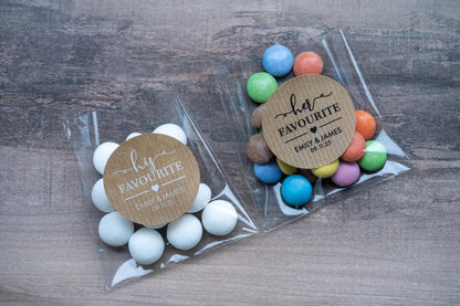 Custom brown kraft stickers in a choice of white and black ink. On the stickers are written His or Her Favourite and the name of the married couple on the bottom. The sticker is finished with the wedding date.
