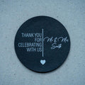 Round black sticker with white text