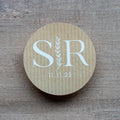 Custom kraft monogram wedding stickers with couple's initials and a leaf branch design.
