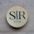 Custom kraft monogram wedding stickers with couple's initials and a leaf branch design