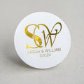 Round white gloss sticker with gold monogram and text.