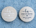 Custom brown kraft stickers in a choice of white and black ink. On the stickers are written His or Her Favourite and the name of the married couple on the bottom. 