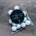 A clear plastic packaging containing white mints with a black personalised sticker on top displaying a thank you message.