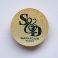 Round kraft sticker with 'S & D' initials and 'Sarah & David 10.10.24' text on a white background
