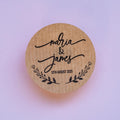 Round kraft sticker with 'Maria & James 13th August 2025' on a light purple background