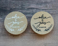Two kraft stickers with 'Maria & James' and wedding date on a wooden surface