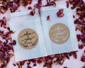 A custom kraft sticker with the names of the happy couple in a lovely handwritten font. The names sit in the middle of the sticker with a wreath frame at the bottom. The stickers come in black or white print.