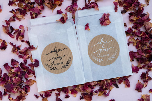 A custom kraft sticker with the names of the happy couple in a lovely handwritten font. The names sit in the middle of the sticker with a wreath frame at the bottom. The stickers come in black or white print.