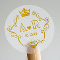 A round clear sticker with a crown frame monogram design, featuring gold print on a white background.